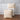 fabric carry bags with 'St. Geneve' branding on a wooden floor against a gray paneled wall.