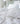 White st geneve down comforter and pillows on a bed in a softly lit room